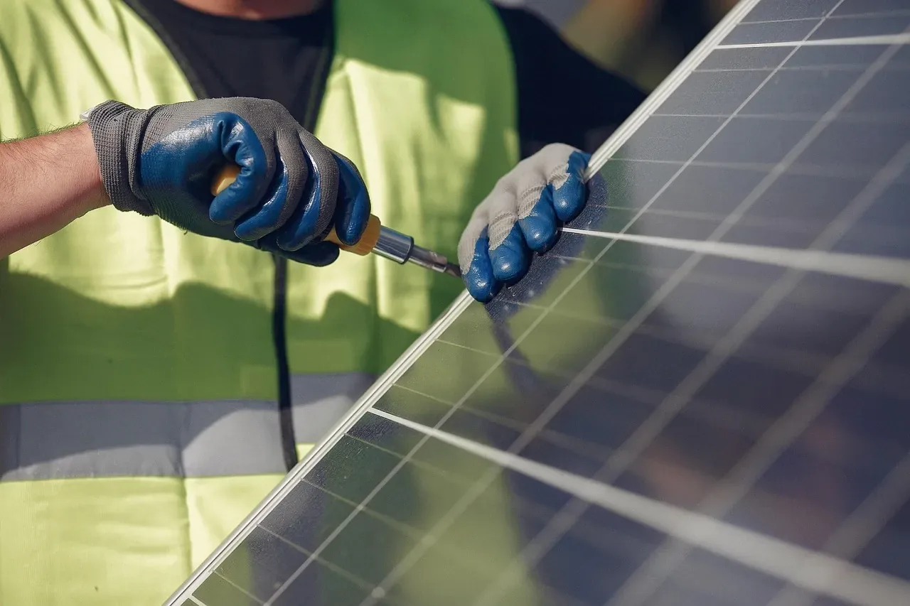Installer fitting a solar panel