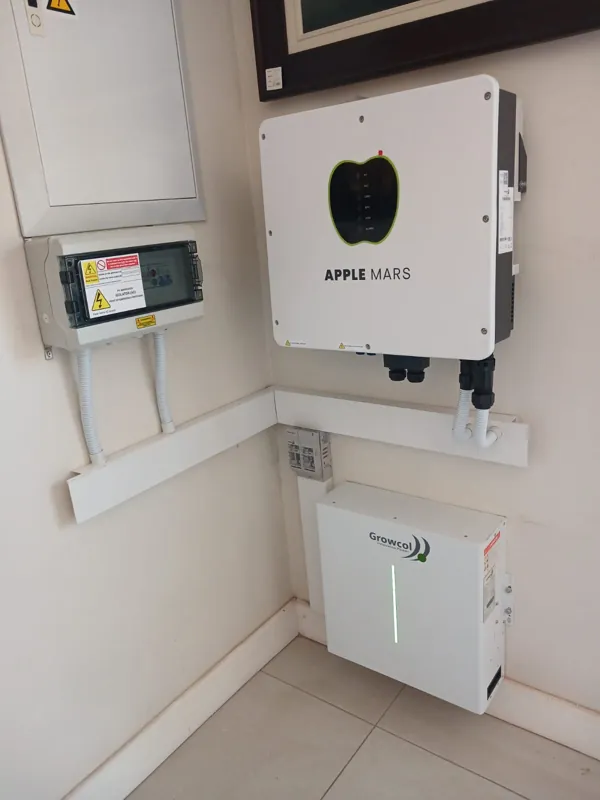 Apple Mars inverter above a battery on an indoor wall